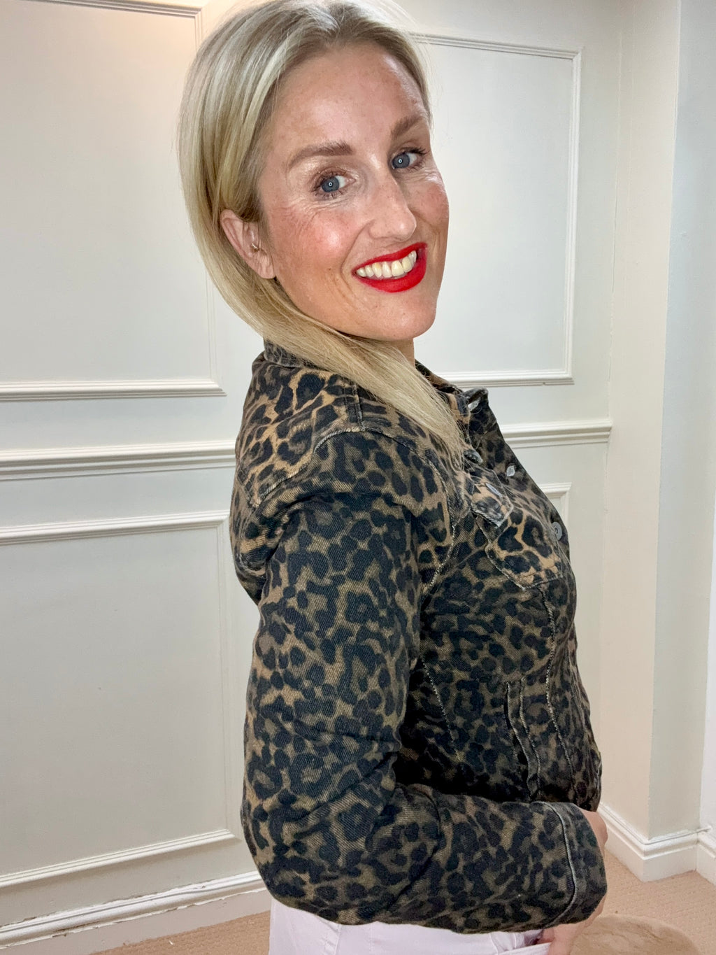 Side view of the Xafar Denim Jacket in Dark Leopard on a model, showing the leopard pattern and long sleeves.