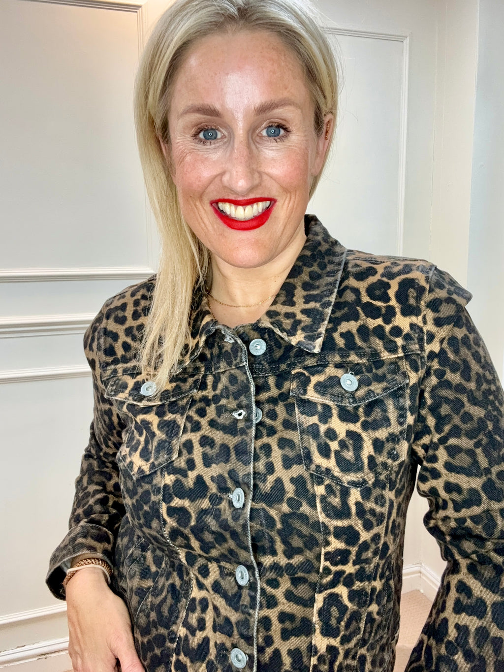 Model wearing the Xafar Denim Jacket in Dark Leopard, showing a pointed collar, silver-tone buttons and chest flap pockets.
