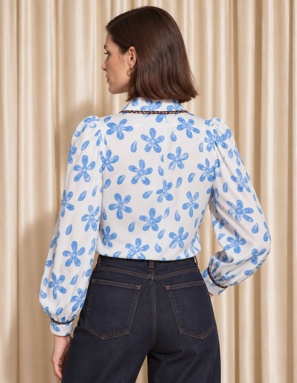 Back view of the Siro white floral blouse with long gathered sleeves.