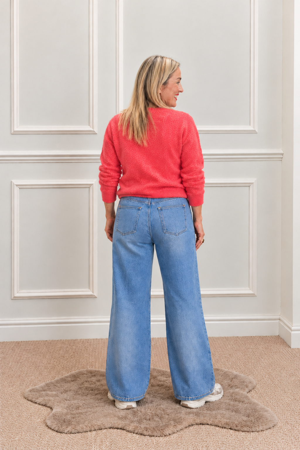 Back view of the Hester mid-blue jeans with plain back pockets and wide legs.