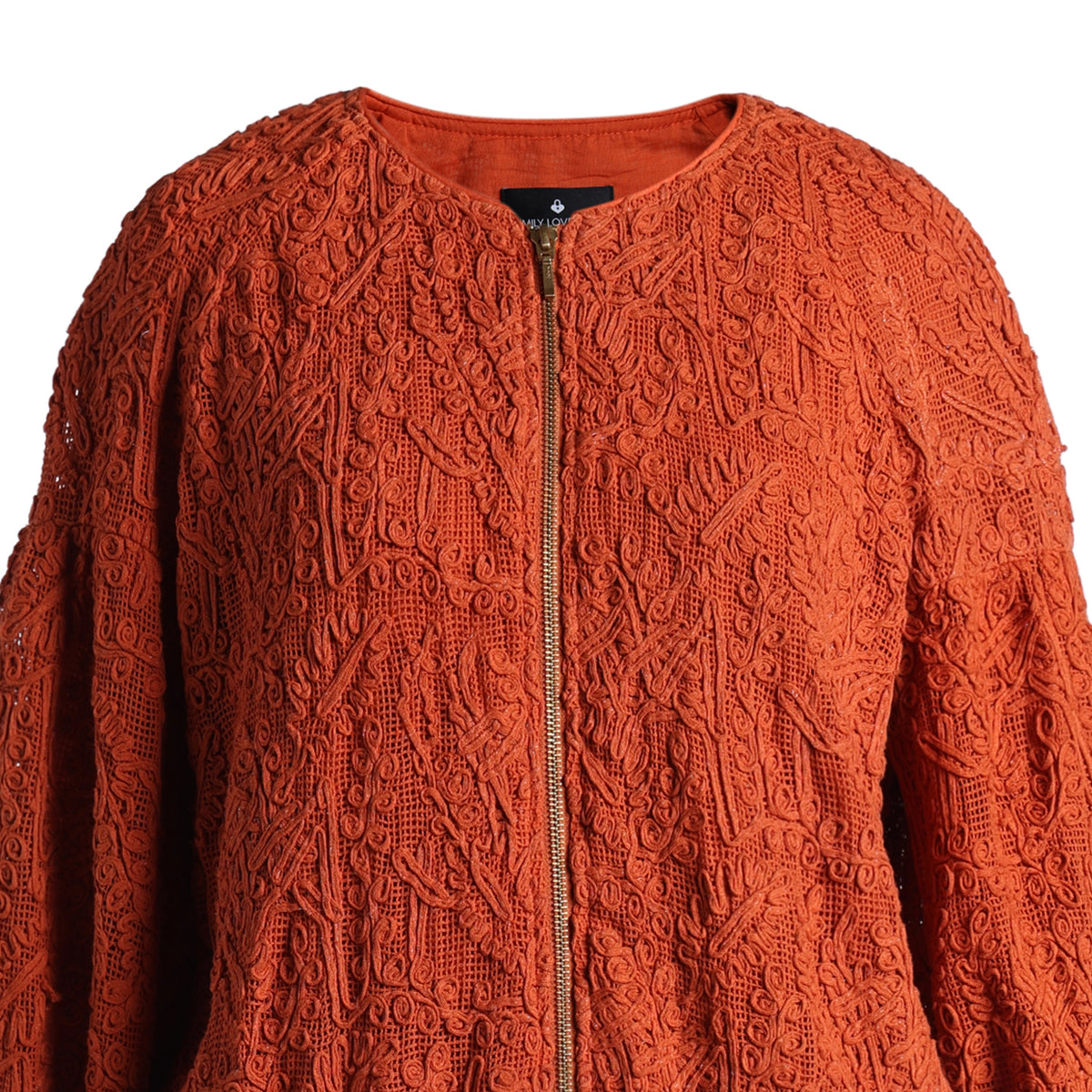 Emelia Jacket in Burnt Orange, close-up of the raised tone-on-tone embroidery and brass zip