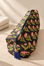 Maison de Belle Grand Wash Bag in Black Bloom, quilted black cotton with pink and lime block-printed flowers and a blue tassel