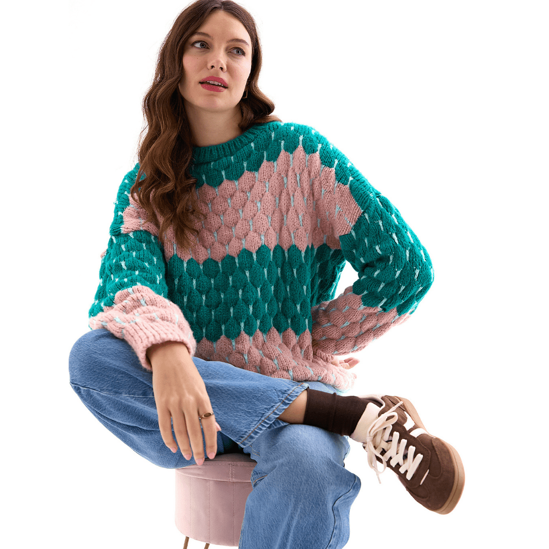 Marissa Bubble Stitch Jumper in emerald green and soft pink, worn with jeans