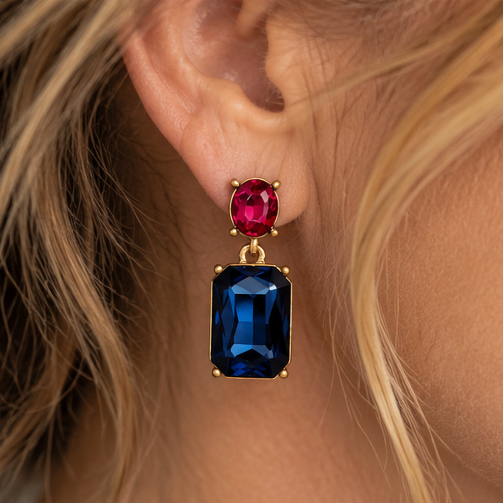 Close-up of Navy and Rose Pink drop earring worn by a mature woman, showing oval pink stud and rectangular navy gemstone