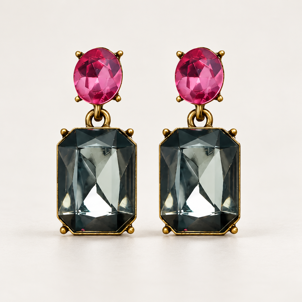 Slate Grey and Pink Oval Twin Gem earrings with fuchsia oval studs and smoky-grey faceted rectangular drops against a warm ivory studio background