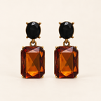 Walnut and Black Oval Twin Gem earrings front studio image, black oval studs and rectangular walnut-amber drops