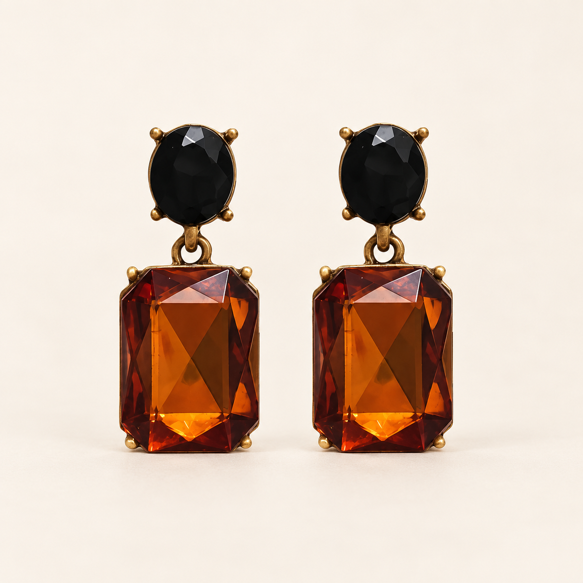 Walnut and Black Oval Twin Gem earrings front studio image, black oval studs and rectangular walnut-amber drops
