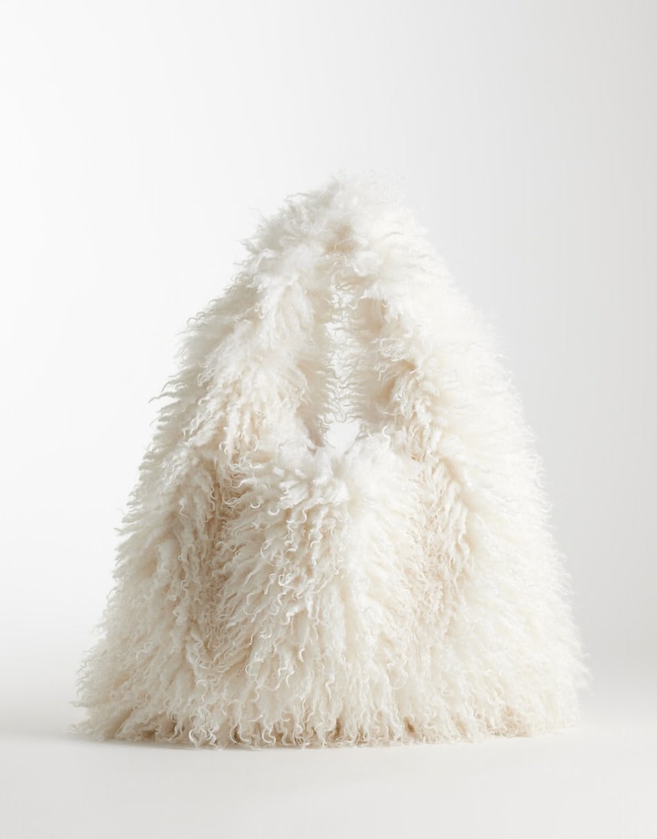 Ruthie Faux Fur Bag in Winter White, a shaggy curly long-pile creamy faux fur bag with a built-in handle