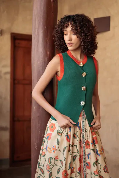 Emily Lovelock Teri Waistcoat in Deep Emerald with burnt orange trim, worn with a printed maxi skirt