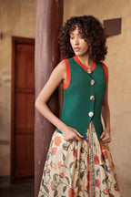 Emily Lovelock Teri Waistcoat in Deep Emerald with burnt orange trim, worn with a printed maxi skirt