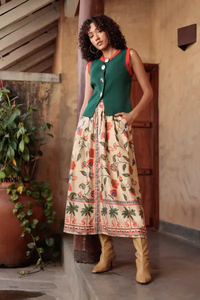 Teri Waistcoat in Deep Emerald, full-length view with a printed skirt and boots
