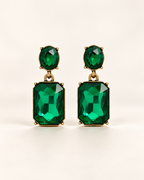 Twin Gem Emerald earrings, front studio view with oval green stud and rectangular emerald-cut drops in antique gold